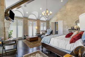 Bedroom with high vaulted ceiling, an inviting chandelier, access to outside, recessed lighting, and hardwood / wood-style floors