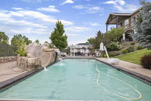 View of swimming pool with a fenced in pool, a patio area, and fence