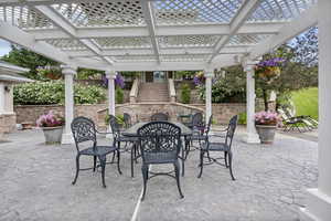View of patio with outdoor dining space and a pergola