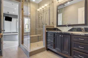 Bathroom with vanity, a stall shower, and recessed lighting