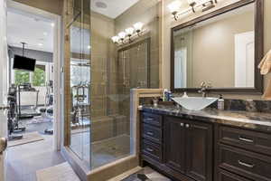 Full bath with vanity, a shower stall, and recessed lighting