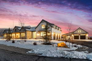 Rear view of property with metal roof, driveway, and a standing seam roof
