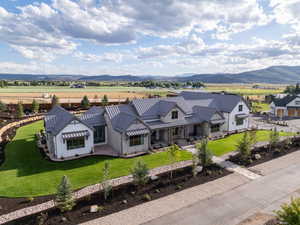 View of front of house with a front lawn, a mountain view, metal roof, and a standing seam roof