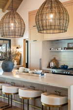 Bar featuring pendant lighting, stove, and beam ceiling