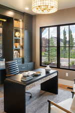 Office area with baseboards, wood finished floors, and visible vents