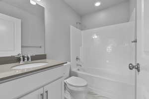 Full bath with vanity, marble finish floor, shower / bathtub combination, toilet, and recessed lighting
