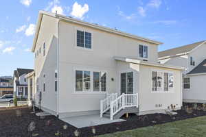 Back of property featuring stucco siding