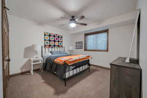 Bedroom featuring carpet flooring, baseboards, and ceiling fan