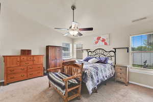 Bedroom featuring a ceiling fan, baseboards, visible vents, and light carpet