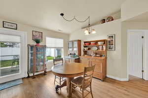 Dining space featuring light wood-style floors, baseboards, and visible vents