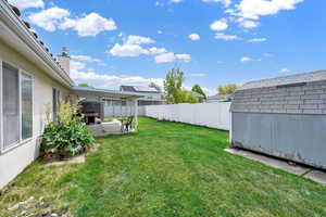 View of yard with an outdoor structure, a patio area, and a shed
