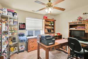 Office with ceiling fan, light carpet, and visible vents