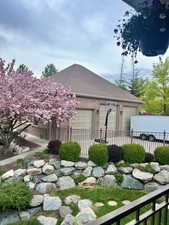 View of yard featuring fence and an attached garage