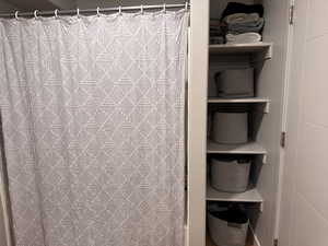 Bathroom with a shower with shower curtain