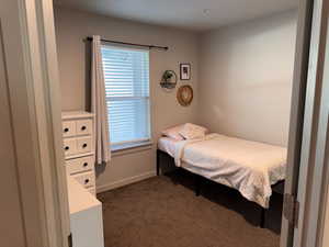 Bedroom featuring dark colored carpet