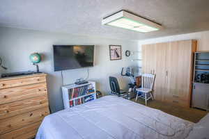 Bedroom featuring a textured ceiling