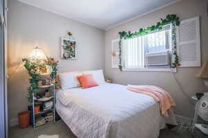 Bedroom featuring carpet and cooling unit