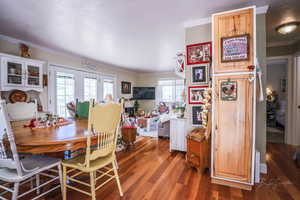 Dining area with crown molding and wood finished floors
