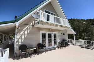 Back of house featuring a patio, french doors, and a balcony