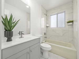 Full bath with vanity, bathtub / shower combination, and toilet