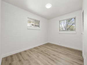 Empty room featuring baseboards and light wood-style flooring