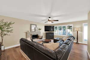 Living room  wood finished floors, and a stone fireplace