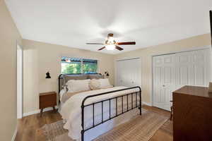 Primary bedroom with 2 closets, beautiful flooring.