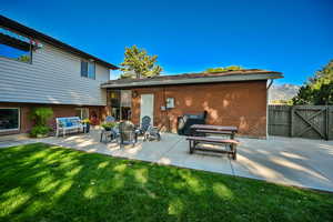 View of patio with fence gate to front.  Perfect shady place to relax.
