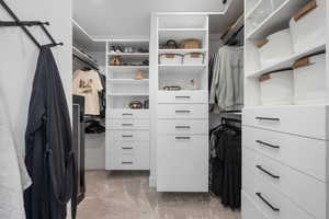 Spacious closet with light colored carpet