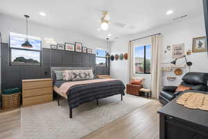 Bedroom with light wood-style floors, recessed lighting, and visible vents