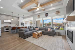 Living area with visible vents, beam ceiling, light wood-style floors, recessed lighting, and wooden ceiling