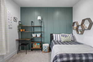 Bedroom with baseboards and carpet flooring