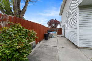 View of property exterior with a patio and fence