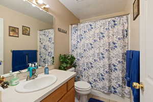 Bathroom with vanity, tile patterned floors, and toilet