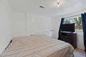 Bedroom with carpet flooring and visible vents