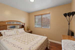 Bedroom featuring baseboards and wood finished floors