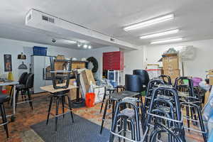 Garage with visible vents and refrigerator