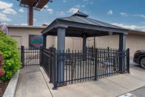 View of gate with a gazebo and fence private yard