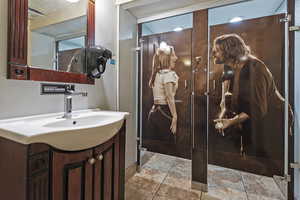 Bathroom with vanity and stone tile floors