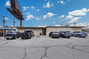 View of building exterior featuring uncovered parking