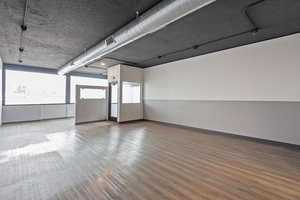 Spare room with baseboards, wood finished floors, and visible vents