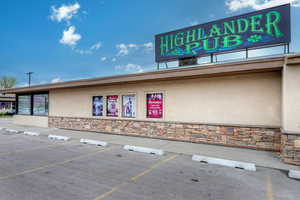 View of building exterior featuring uncovered parking