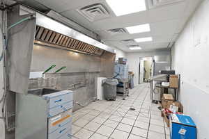 Below grade area featuring visible vents and light tile patterned floors