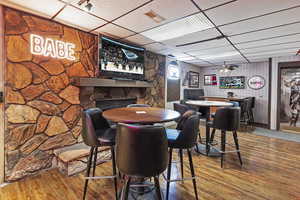 Dining space with visible vents, hardwood / wood-style floors, and a paneled ceiling