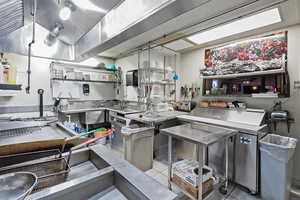 Kitchen featuring fridge and tile patterned floors