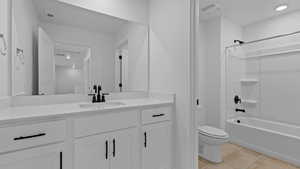 Full bath with vanity, visible vents, toilet, and tub / shower combination