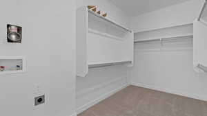Spacious closet featuring carpet flooring