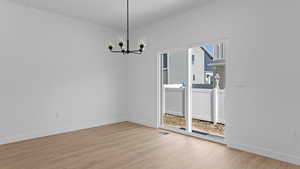 Unfurnished dining area featuring visible vents, baseboards, an inviting chandelier, and light wood finished floors