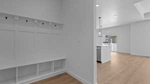 Mudroom with baseboards and light wood finished floors