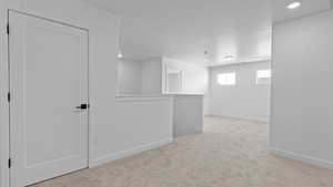 Below grade area with recessed lighting, baseboards, and carpet